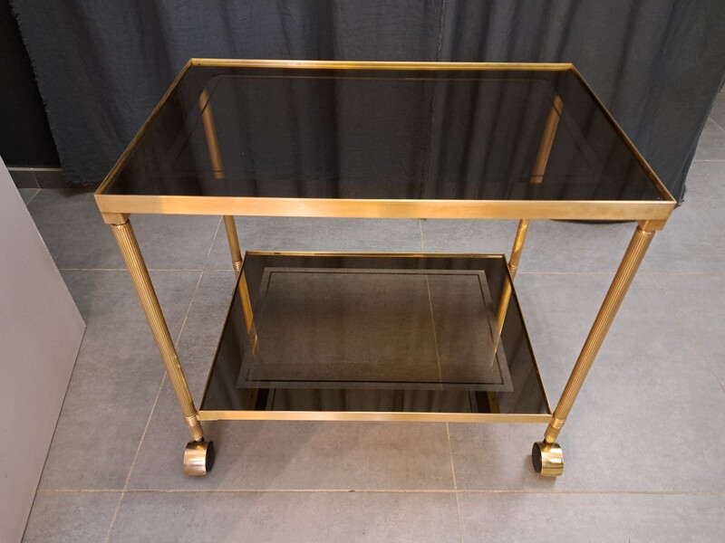 Rolling serving cart in gilded brass with smoked glass tops